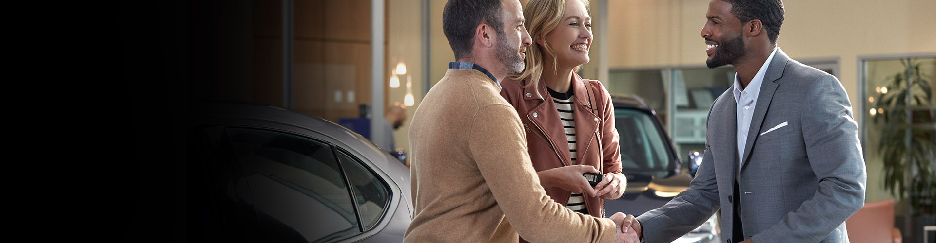 Acura sales professional assisting a customer with vehicle leasing