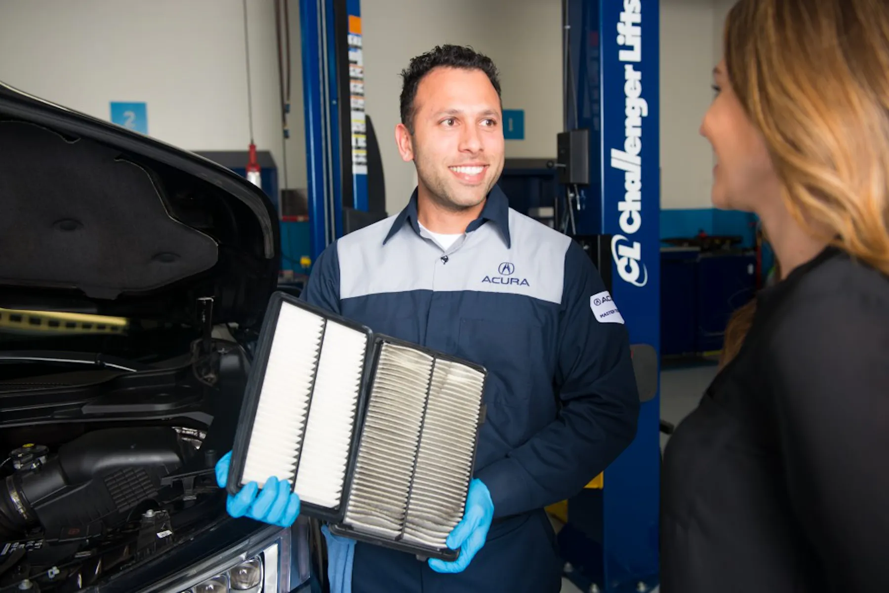 Acura technician comparing vehicle air filters