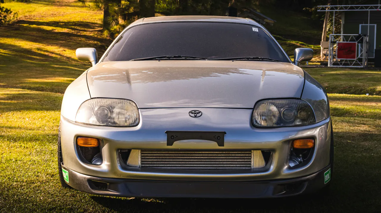 Older Toyota Celica parked on lawn