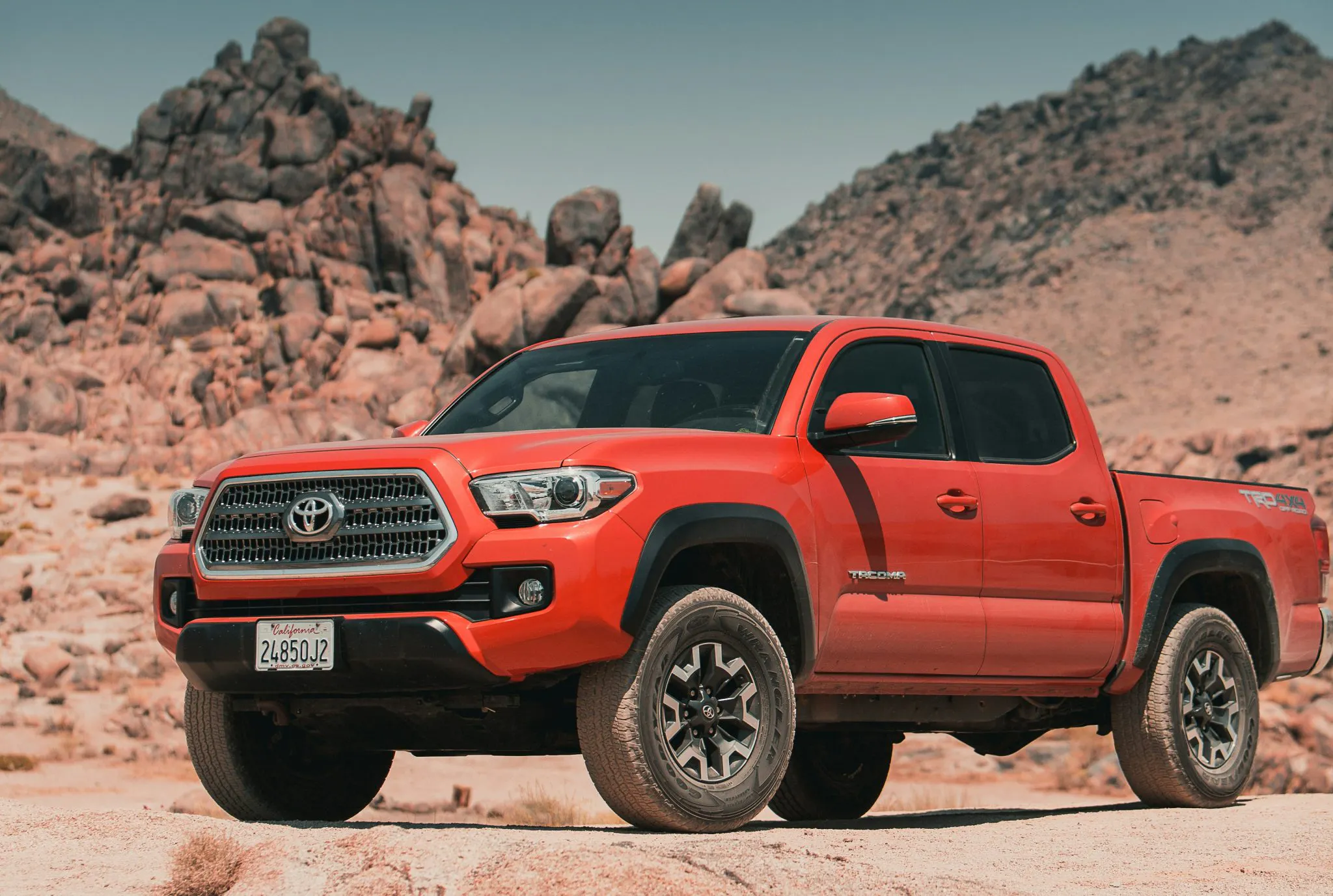 A red Toyota Pick up truck parked in the desert