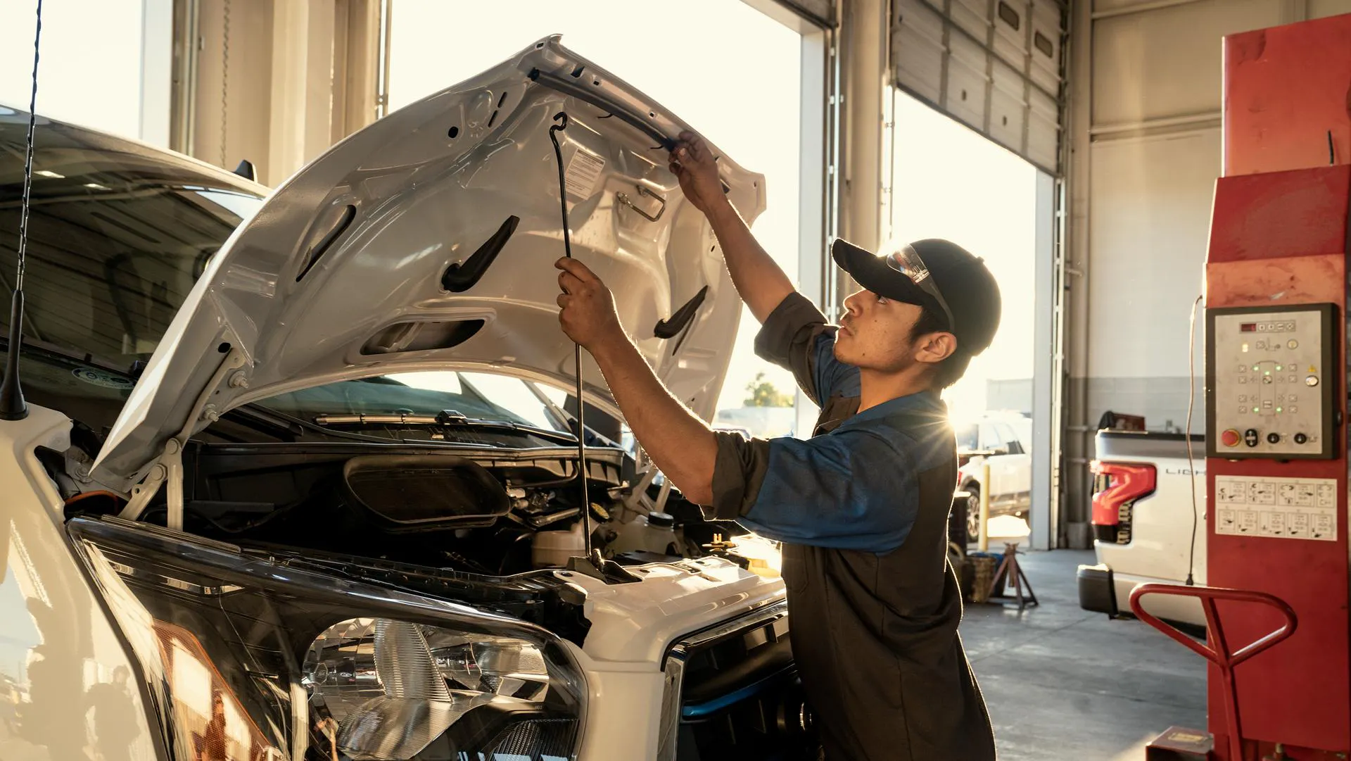 A Ford Service Tech lifts the hood on a Super Duty Truck