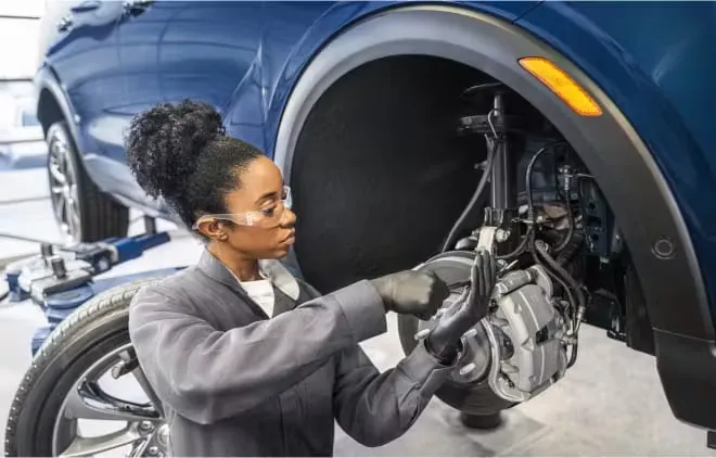 Service technician preparing to work on vehicle brakes