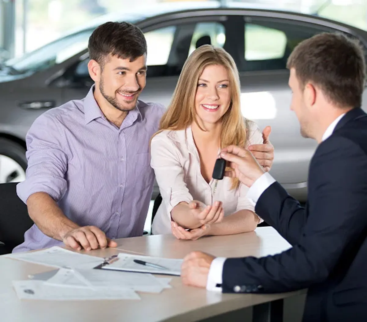 Customers discussing vehicle financing at a dealership