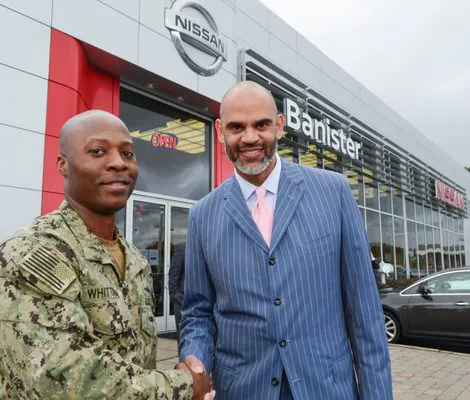 Dan Banister shaking hands with Military person