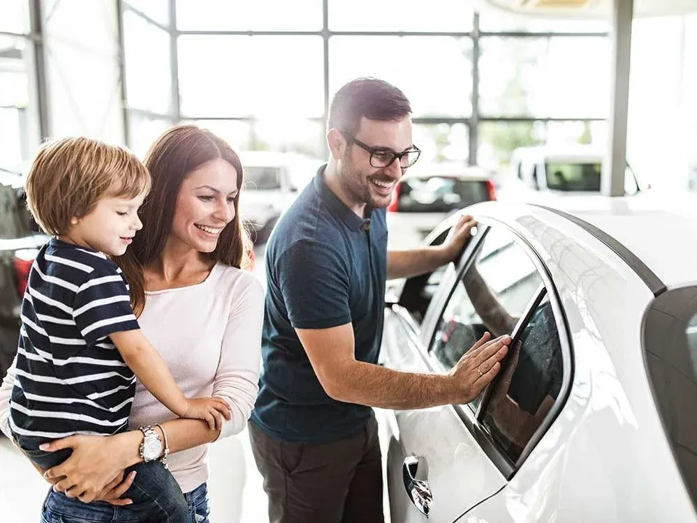 Family looking at cars at a car dealership
