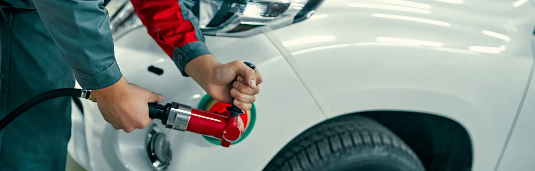 Technician polishing a vehicle during collision repair