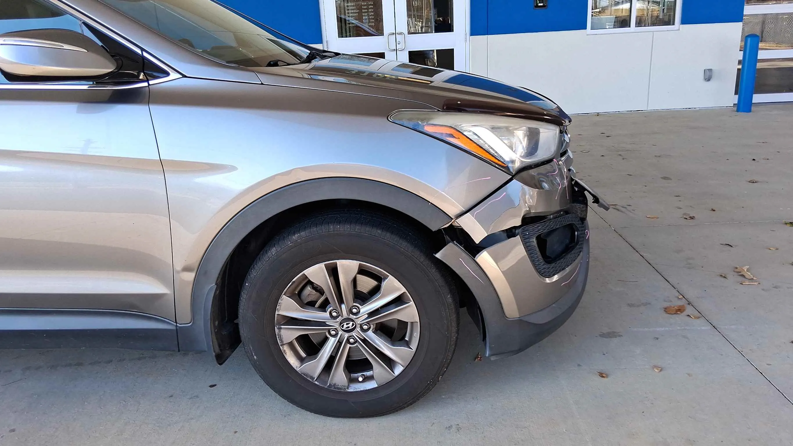 Vehicle with front fender and bumper damage before repair