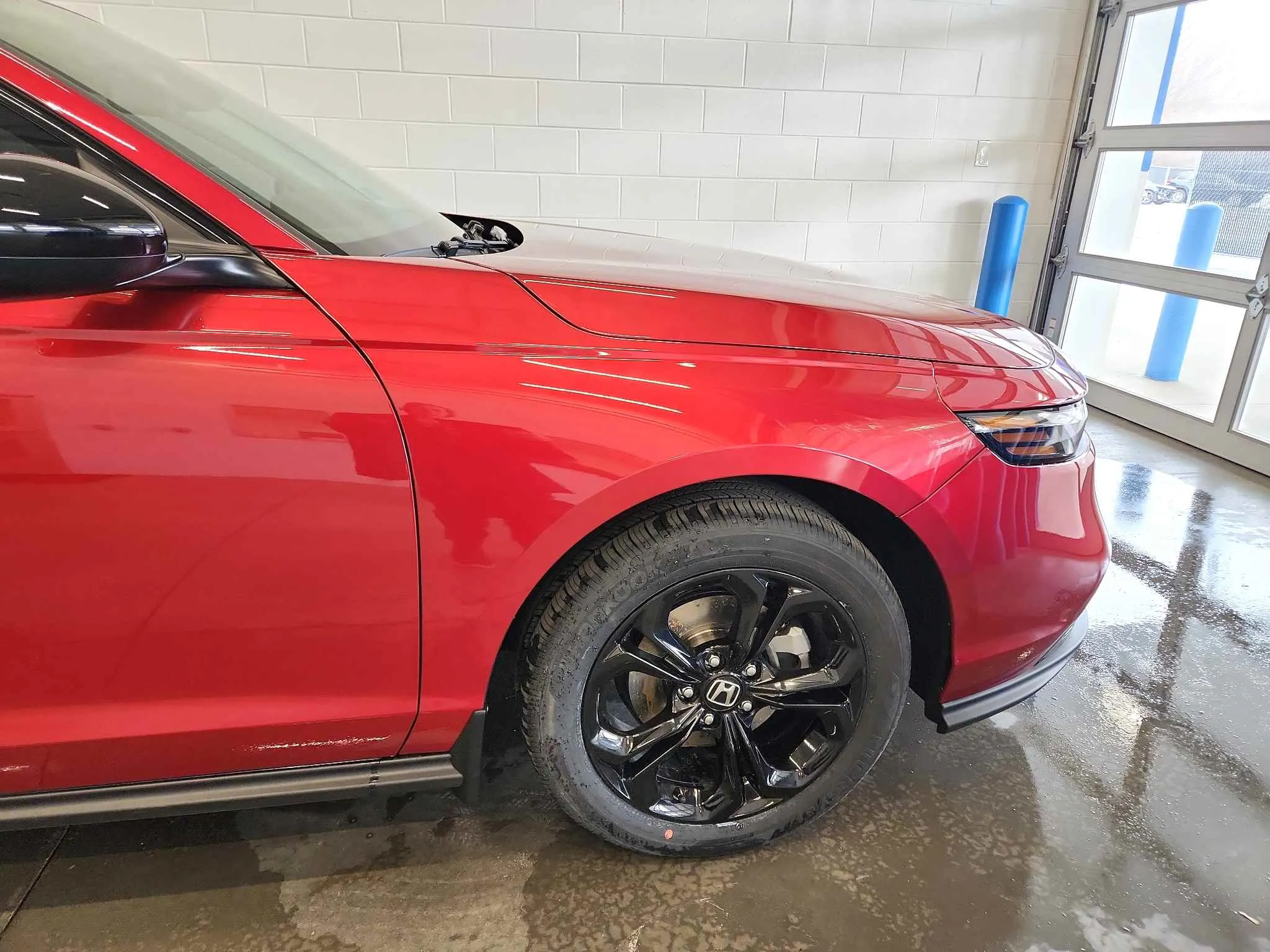 Red vehicle after front fender repair