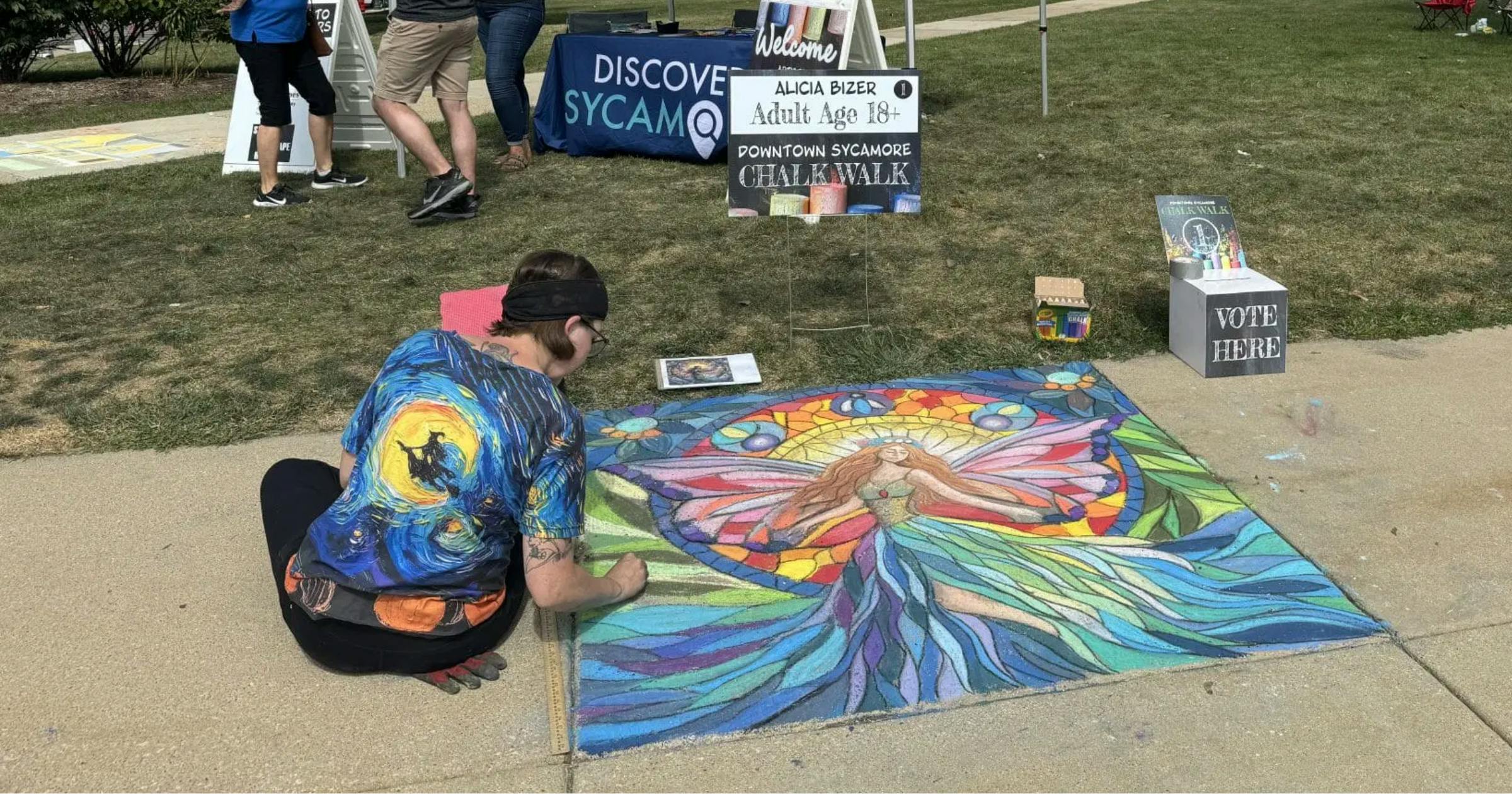 Artist draws an image on side walk using chalk