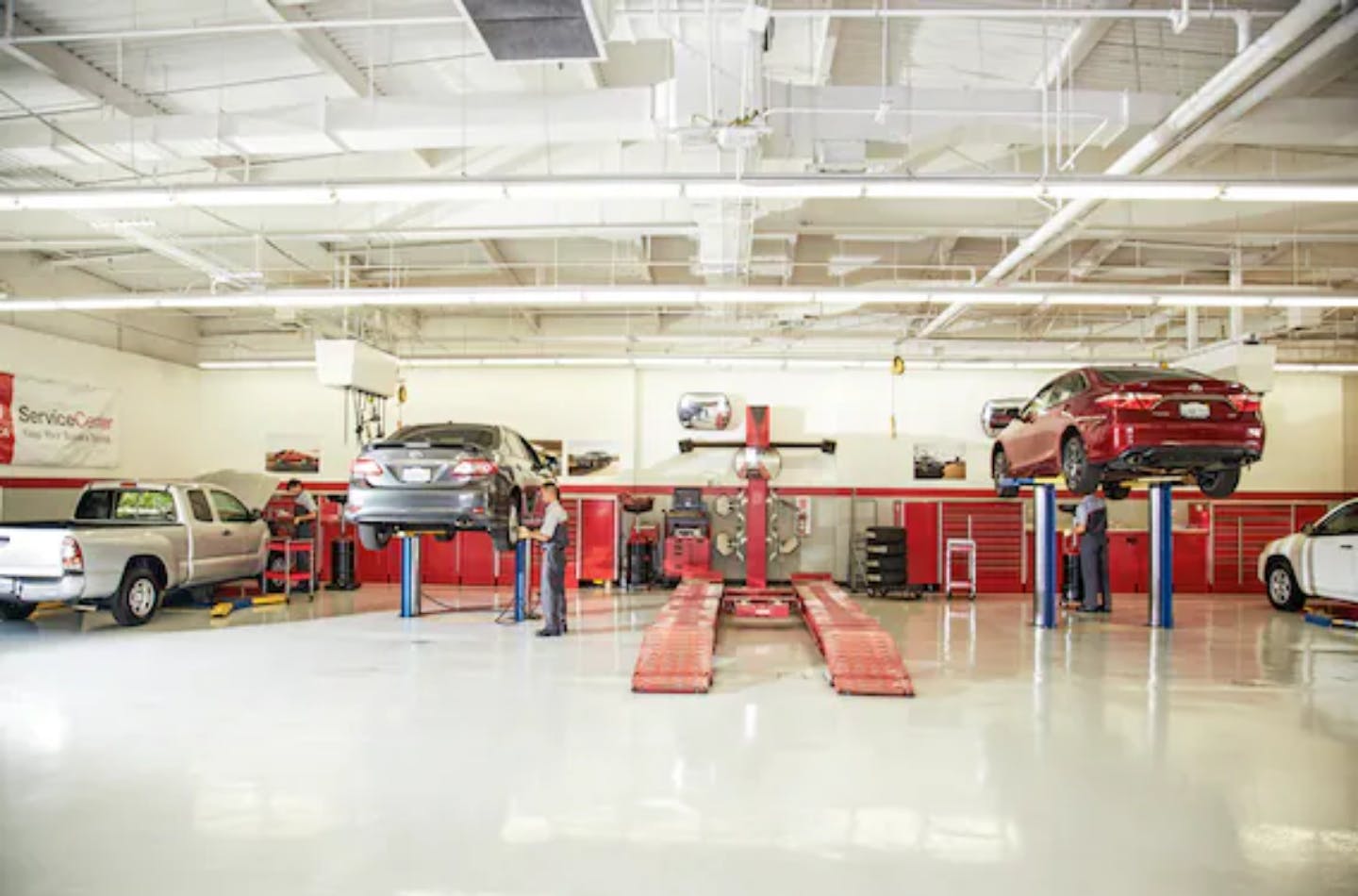 Servicing Your Toyota service garage with vehicles on rack