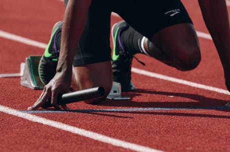 track-field-event-sponsorship-25-7 Close up shot of a man sprinting from a track and field starting line in Memphis, TN..