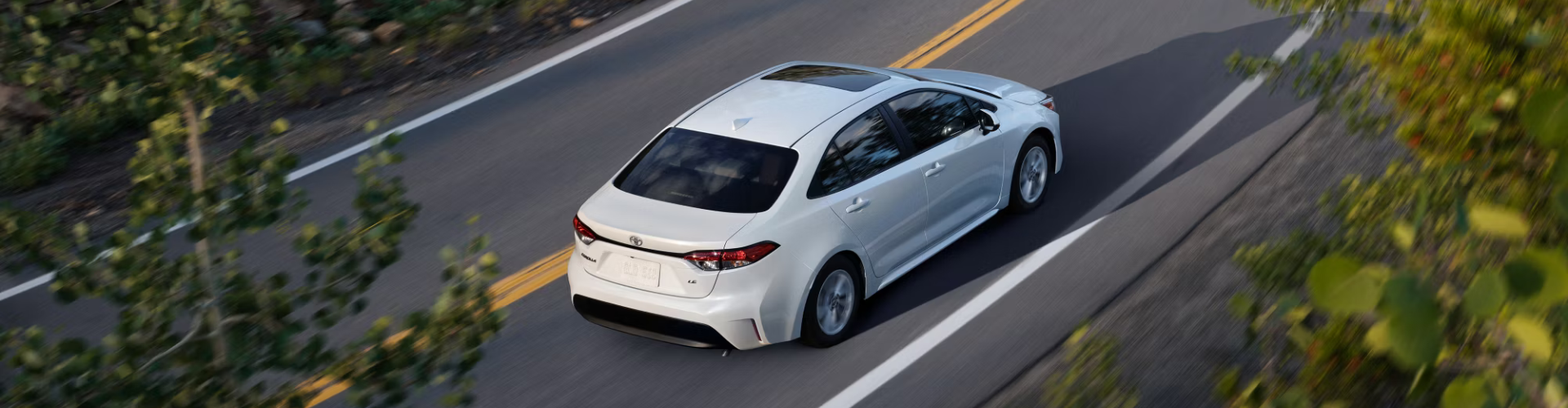 Toyota Corolla driving on pavement