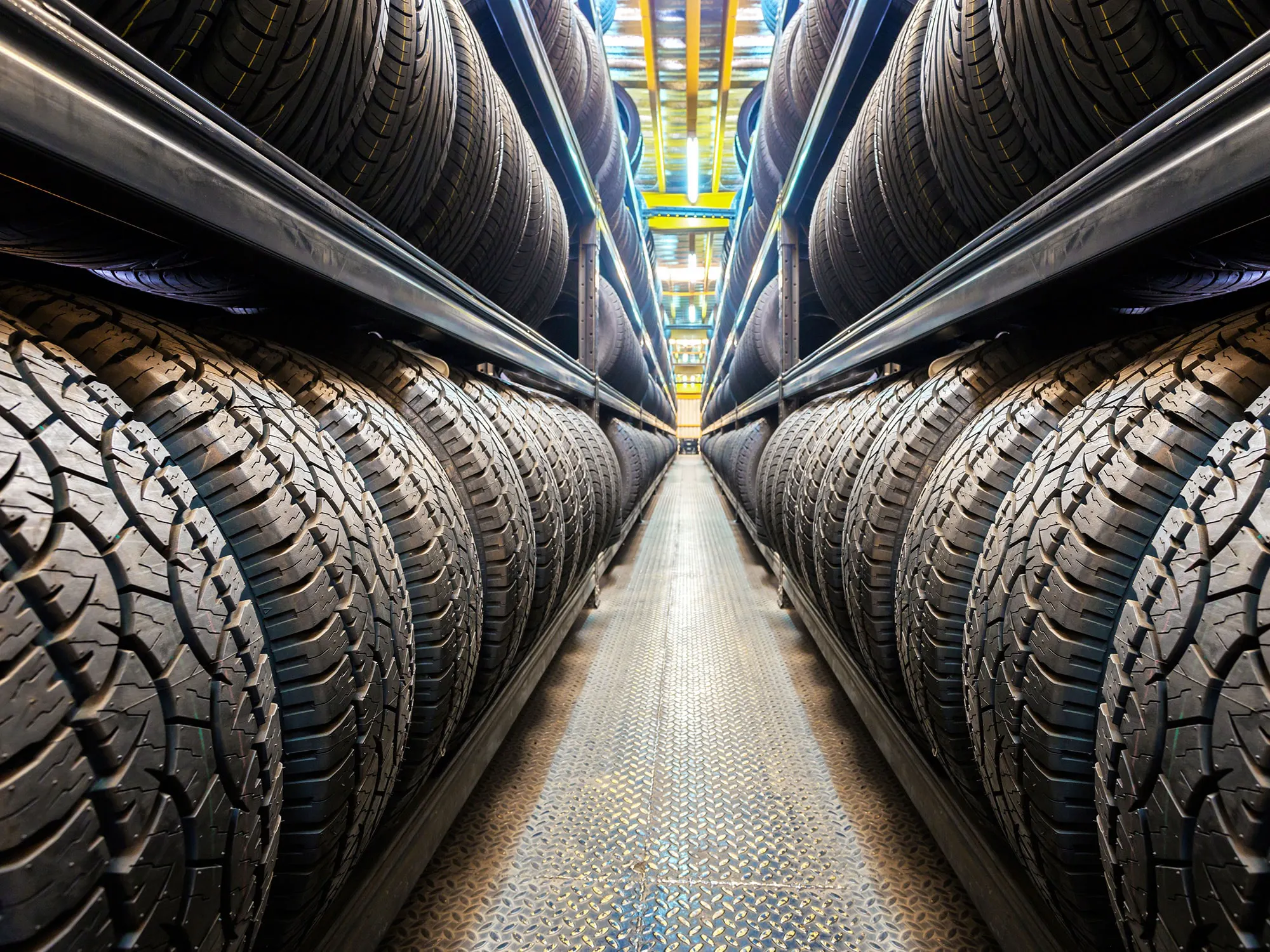 Technician inspecting a vehicle tire