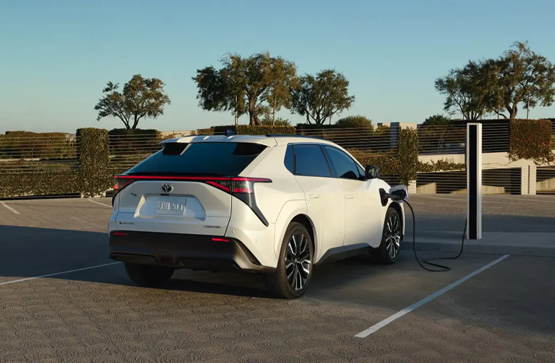 White Toyota battery electric vehicle plugged in at a charging station