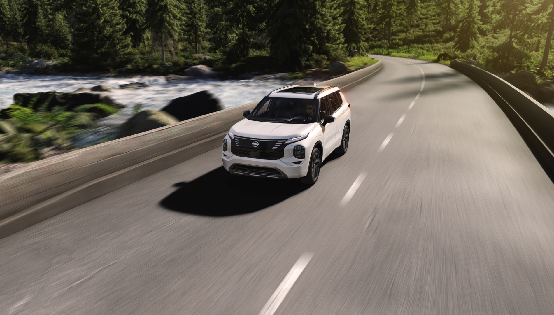 Nissan SUV driving on a scenic road