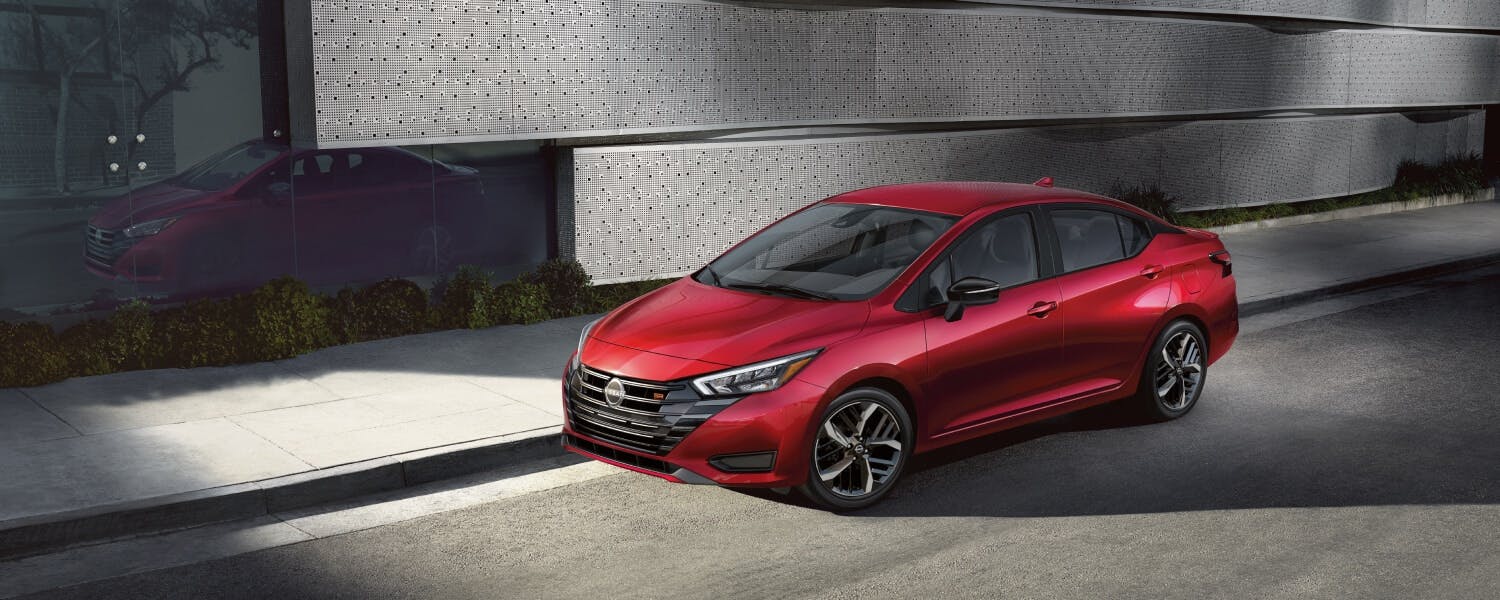 2025-nissan-versa-view-of-bold-front-end-parked-on-a-city-street Nissan Versa Red