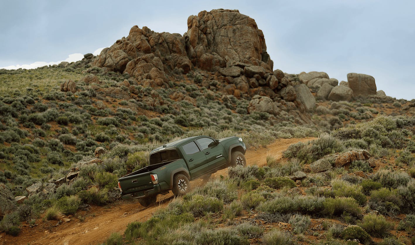 Hunter Green Toyota Tacoma Driving Uphill Offroading