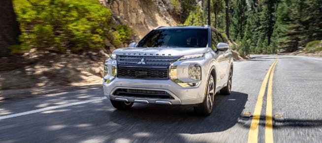 white suv outlander driving front