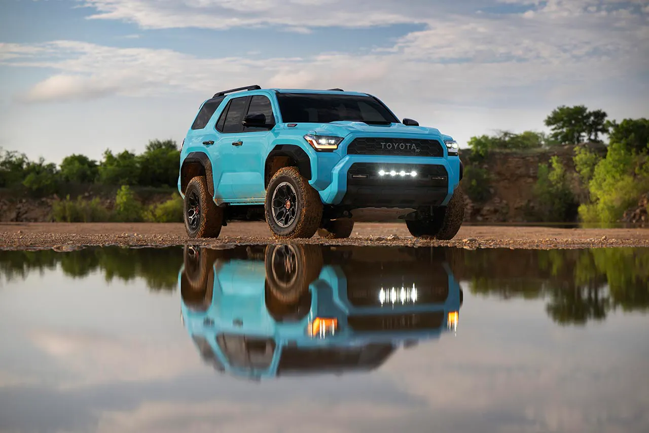 2025 Toyota 4Runner TRD Pro in Cavalry Blue parked on rocky terrain beside a reflective pool
