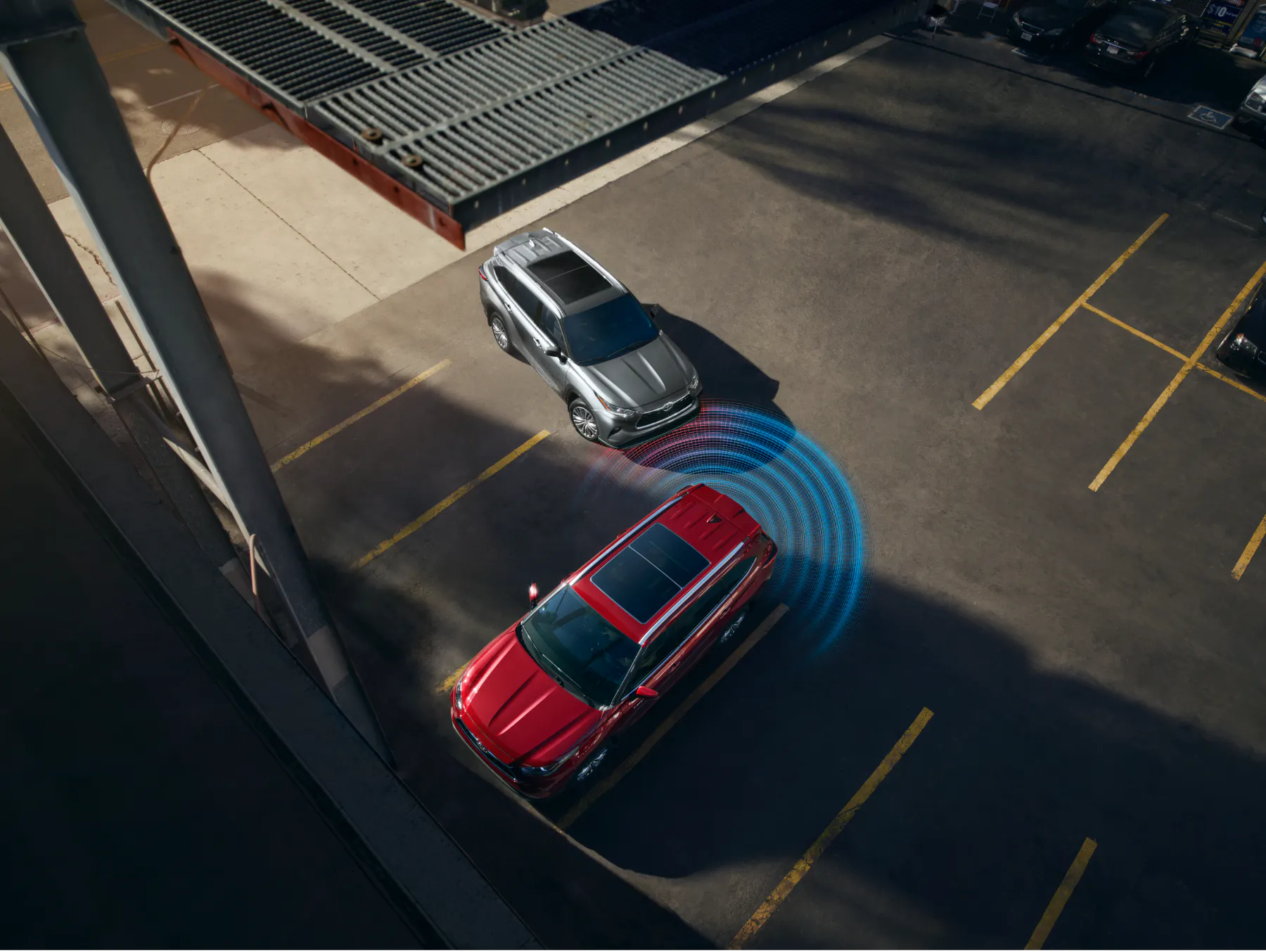 Overhead view showing Toyota Highlander safety sensors in a parking lot