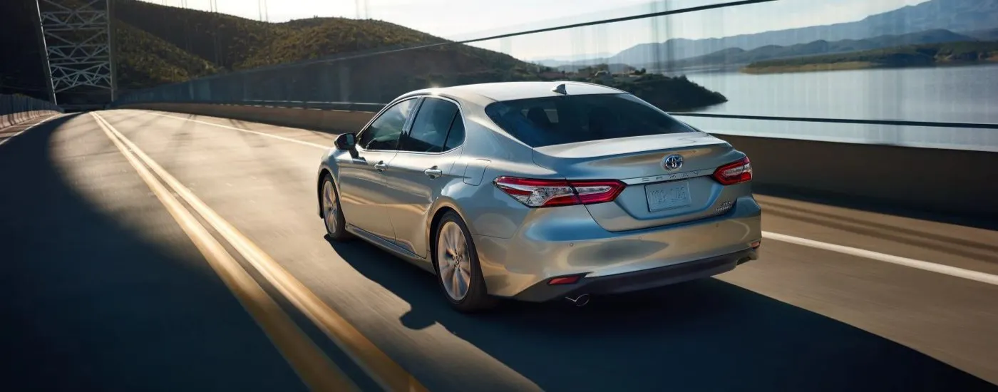 Silver 2020 Toyota Camry XLE driving across a bridge