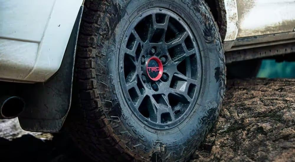 A close-up on the wheel of a white 2023 Toyota 4Runner TRD Pro is shown.