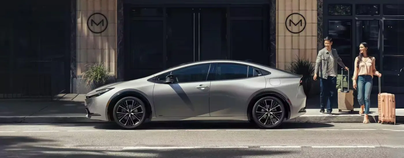 Side view of a silver 2023 Toyota Prius parked on a city street