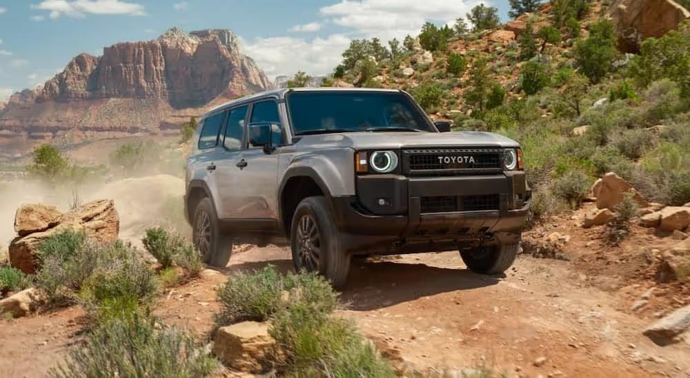 A gray 2023 Toyota Land Cruiser 1958 is shown driving off-road after visiting a Toyota dealer near Atlanta.