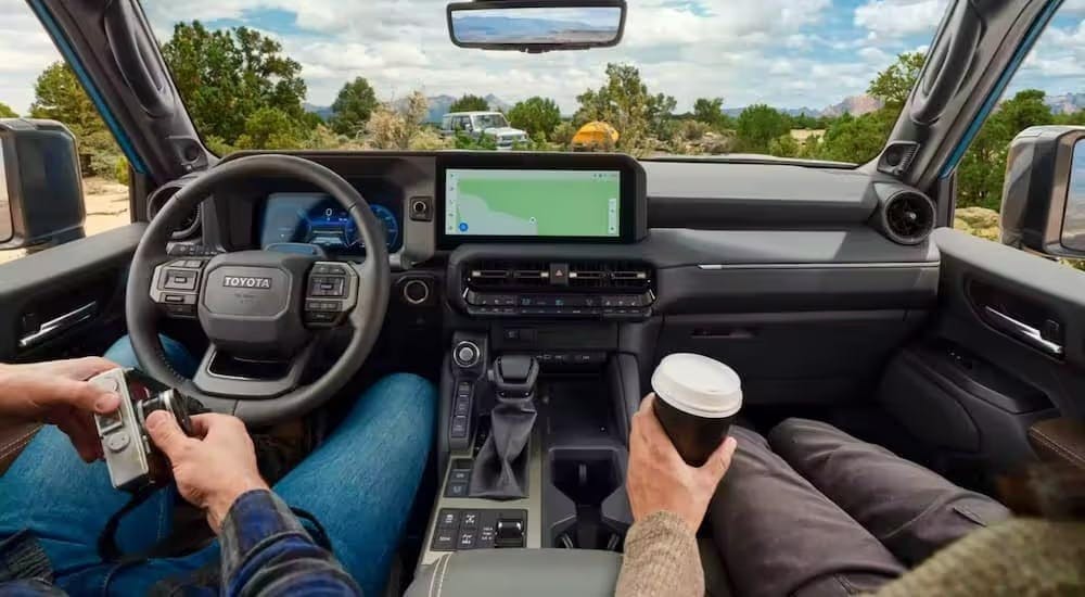 The black interior and dash of a 2024 Toyota Land Cruiser 1958 is shown.