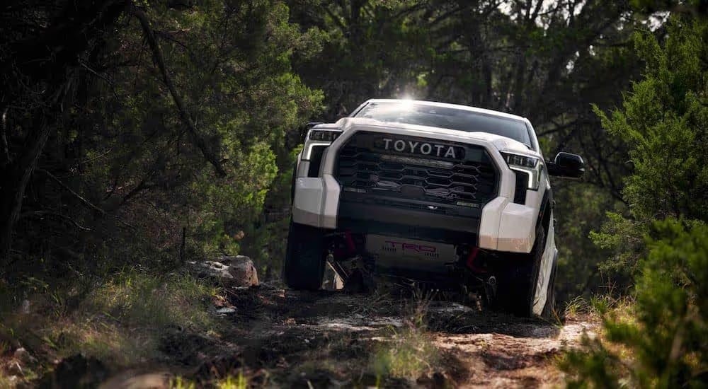 White 2024 Toyota Tundra TRD Pro for sale driving up a hill.