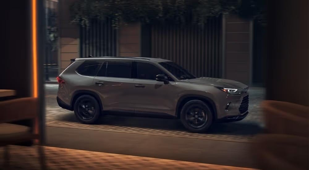 A grey 2025 Toyota Grand Highlander for sale is shown from the side.