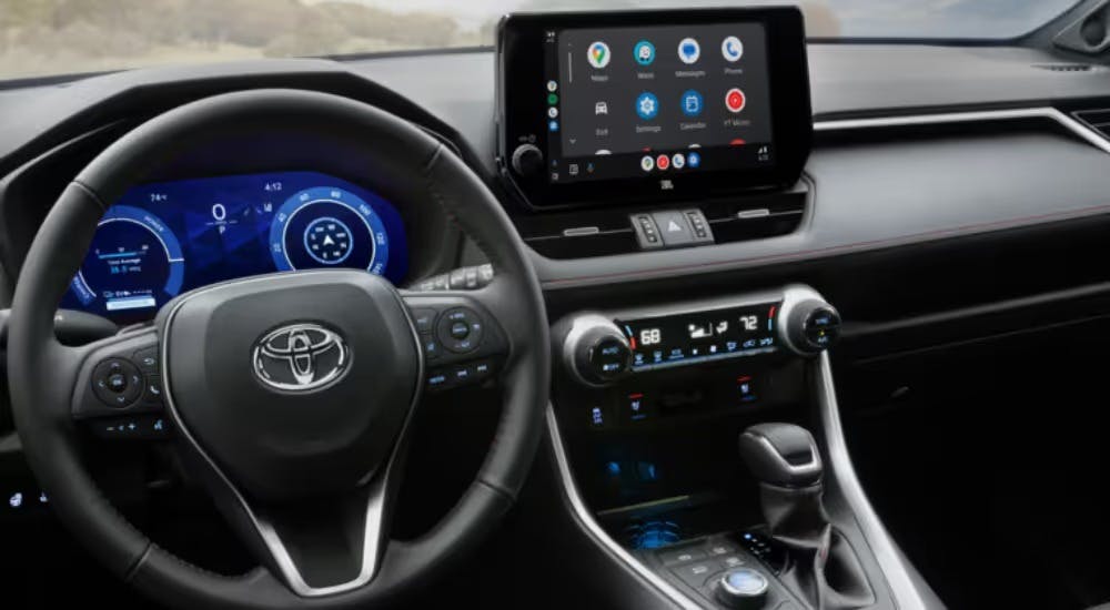 Interior digital gauge cluster and infotainment system on a 2025 Toyota RAV4 PHEV.