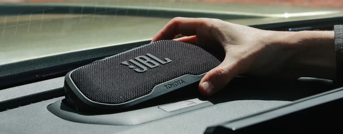 A JBL Flex portable speaker is shown in a 2025 Toyota Tacoma for sale near Alpharetta.