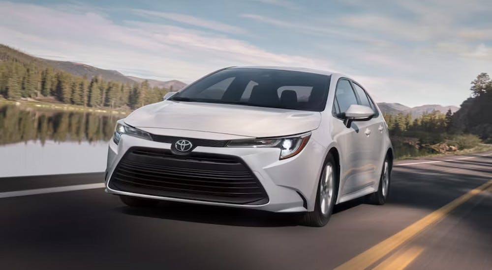 A white 2025 Toyota Corolla Hybrid for sale near Sandy Springs from the front.