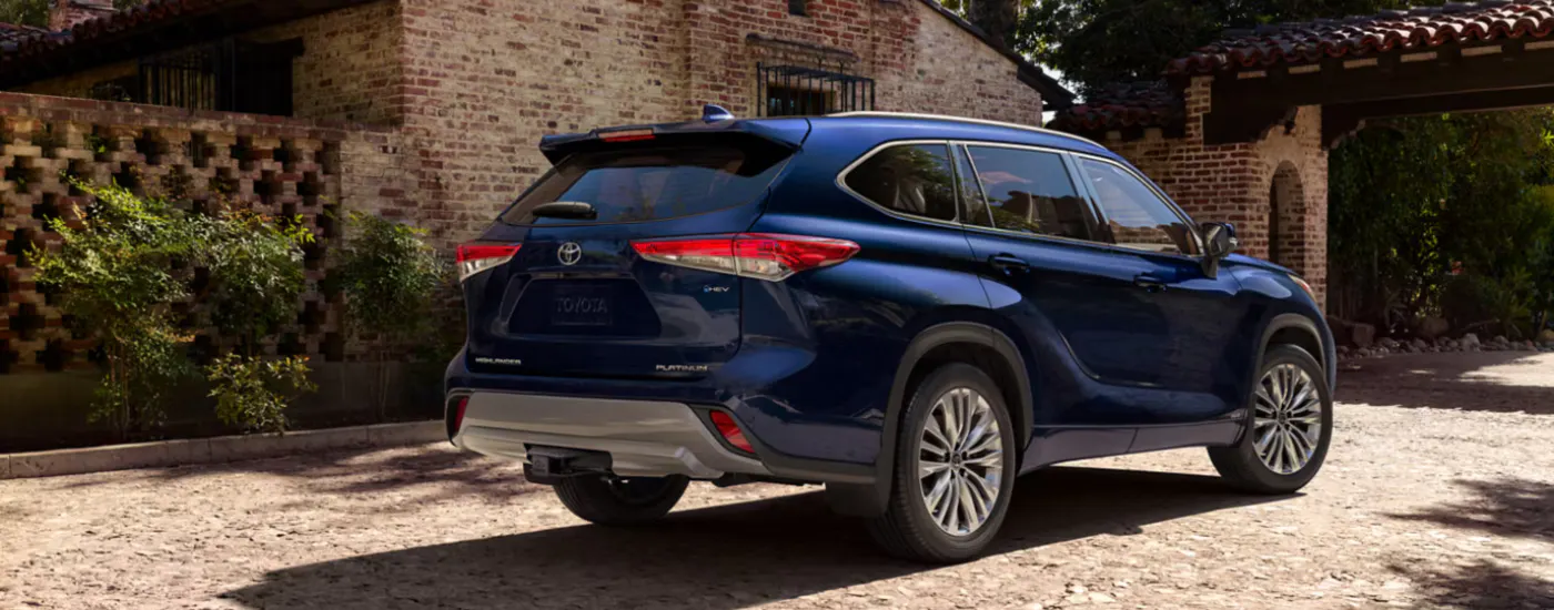 Blue 2026 Toyota Highlander parked in front of a house