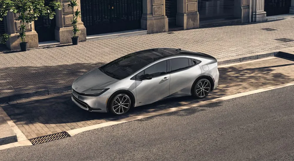 Silver 2026 Toyota Prius parked near a curb.