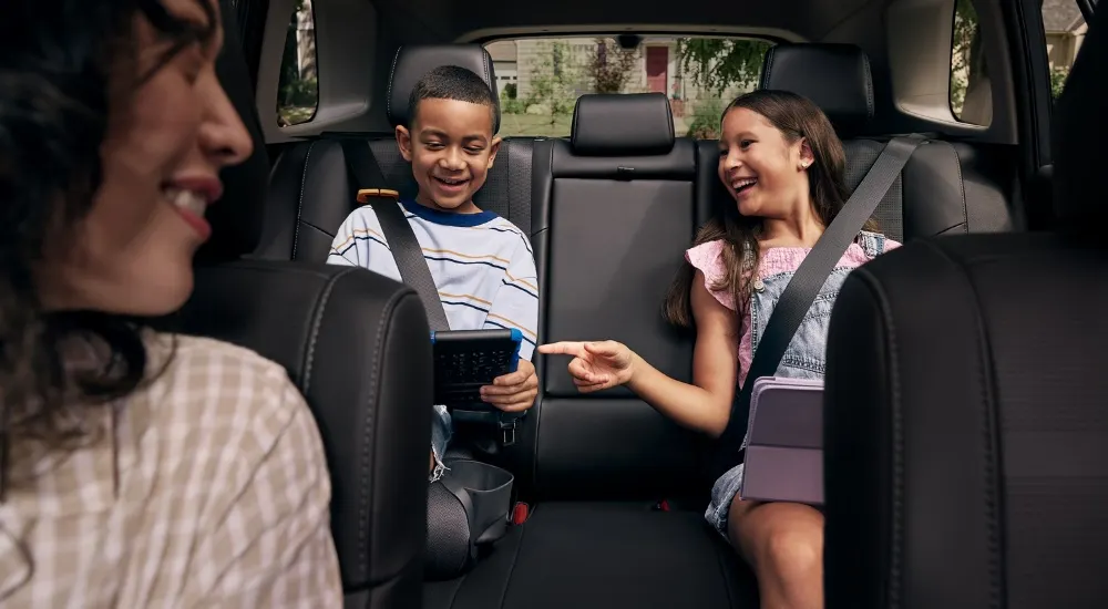 Kids using a tablet in the rear seats of a 2026 Toyota RAV4 Limited