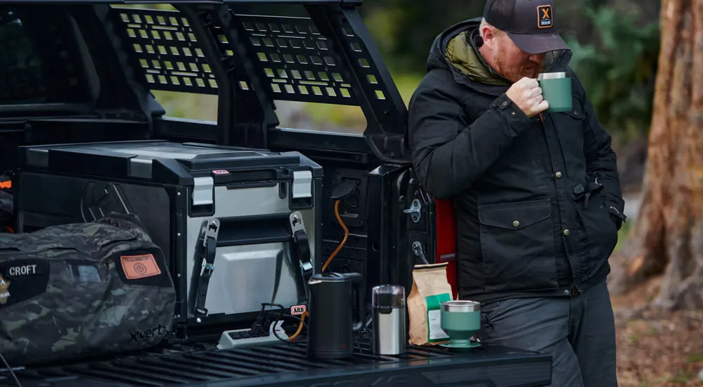 Man near the open bed of a 2026 Toyota Tacoma