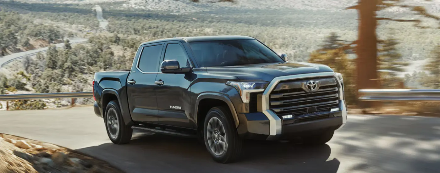 Grey 2026 Toyota Tundra driving up a hill