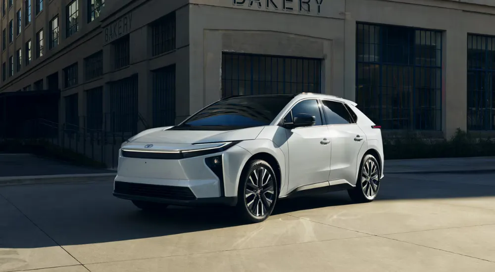 White 2026 Toyota bZ rounding a corner in a city