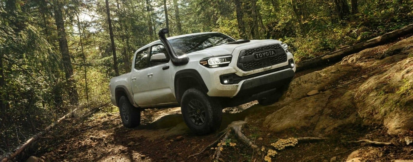 White 2020 Toyota Tacoma TRD Pro driving in a forest