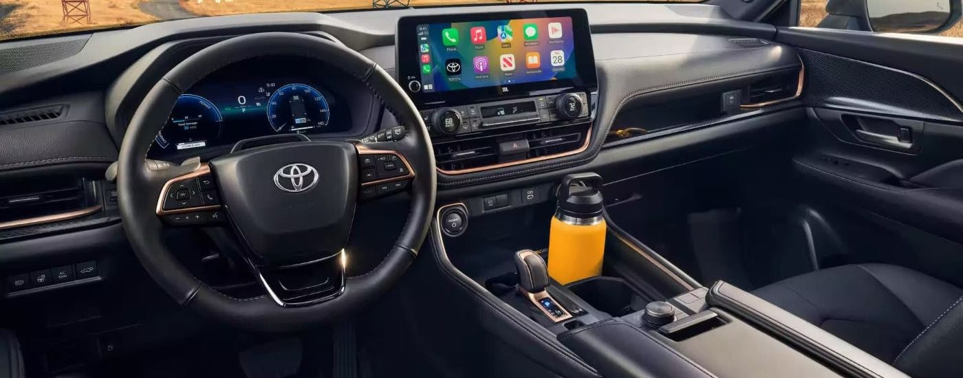The wheel and dashboard inside of a 2024 Toyota Grand Highlander.