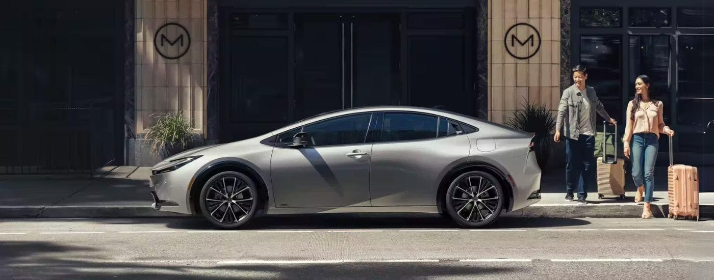 Silver 2023 Toyota Prius is shown parked near a motel