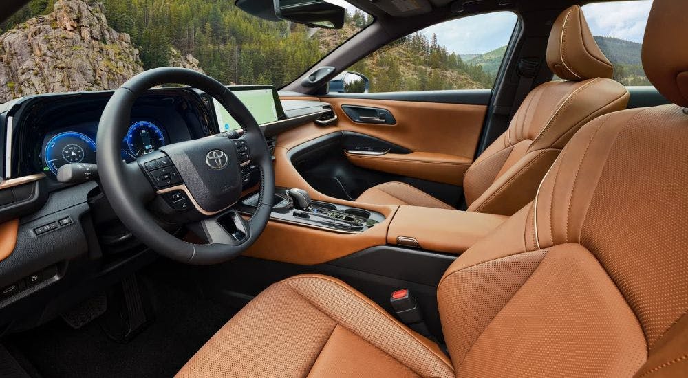 The brown interior of a 2025 Toyota Crown Signia is shown from the driver's seat.