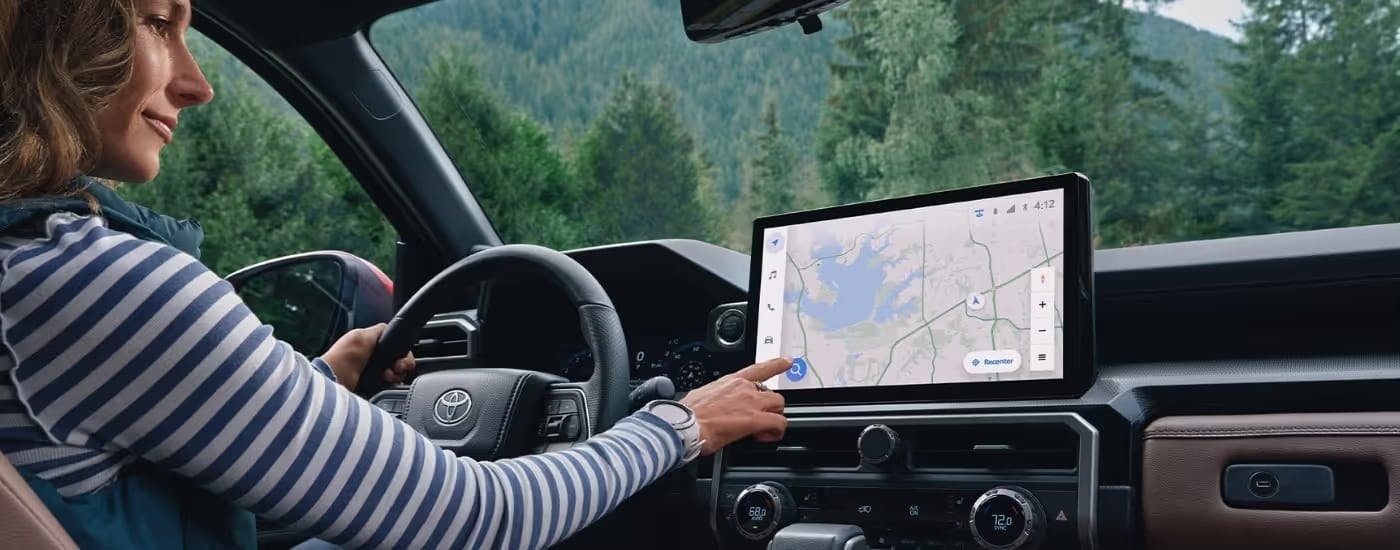Person using the infotainment screen in the interior of a 2025 Toyota 4Runner.