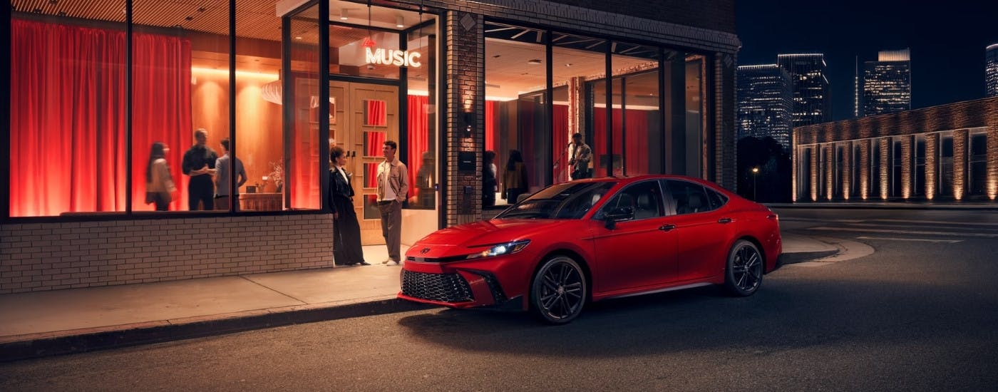 Red 2026 Toyota Camry Nightshade for Sale Near Acworth parked in front of a music venue