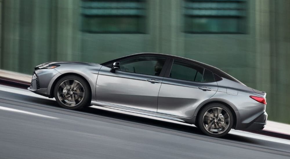 Silver 2025 Toyota Camry for sale near Powder Springs driving up a hill