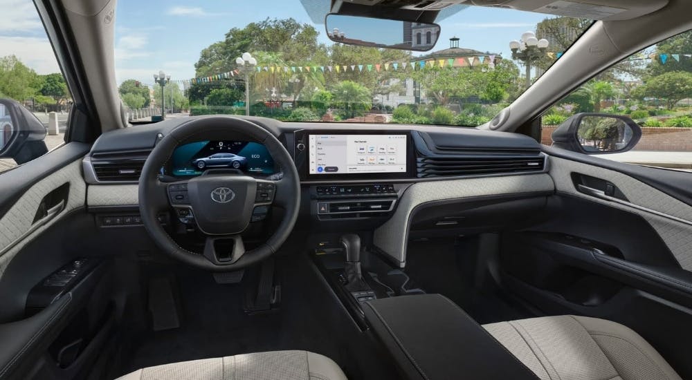 The interior of a 2025 Toyota Camry is shown from the driver's seat.