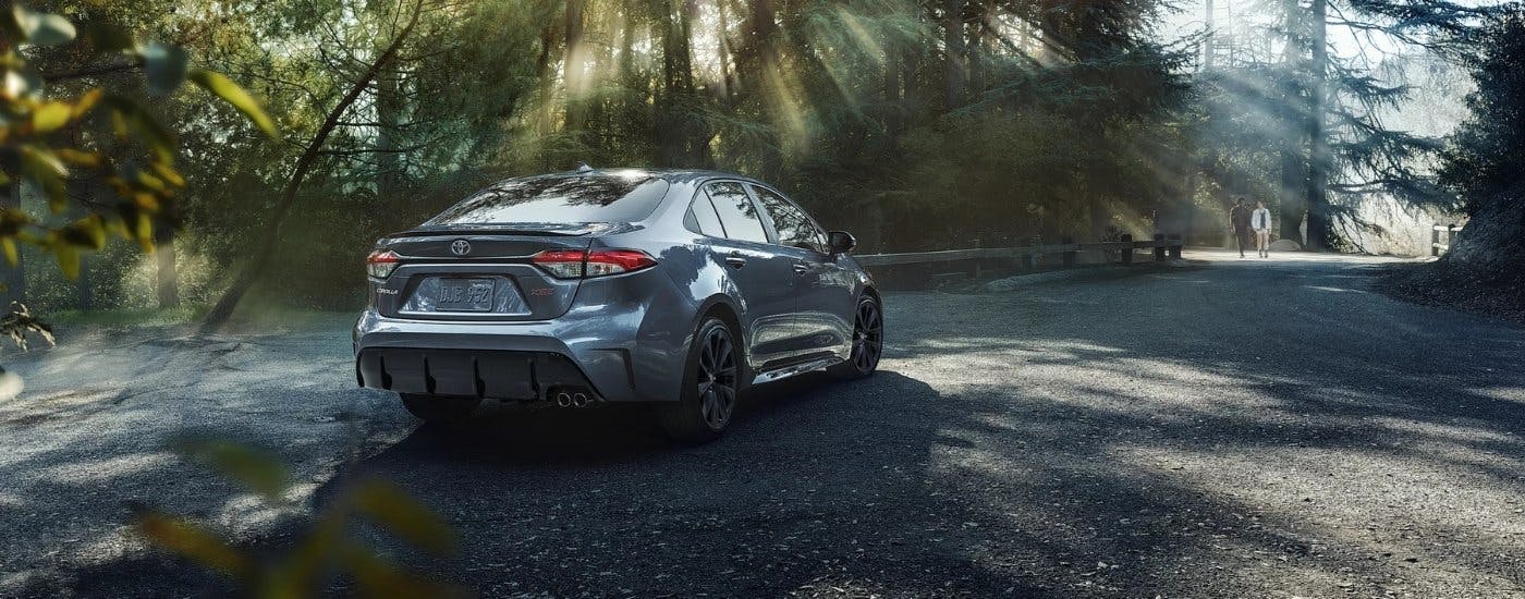 Blue 2026 Toyota Corolla driving down the road