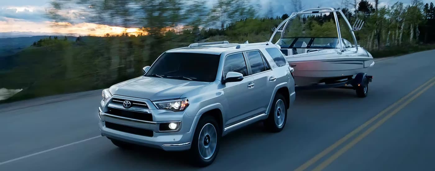 Silver 2023 Toyota 4Runner towing a boat to a Toyota dealer near Dunwoody